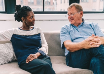 senior man and woman talking about the symptoms of hearing loss