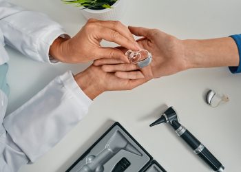 How do hearing aids help with Sensorineural Hearing Loss?