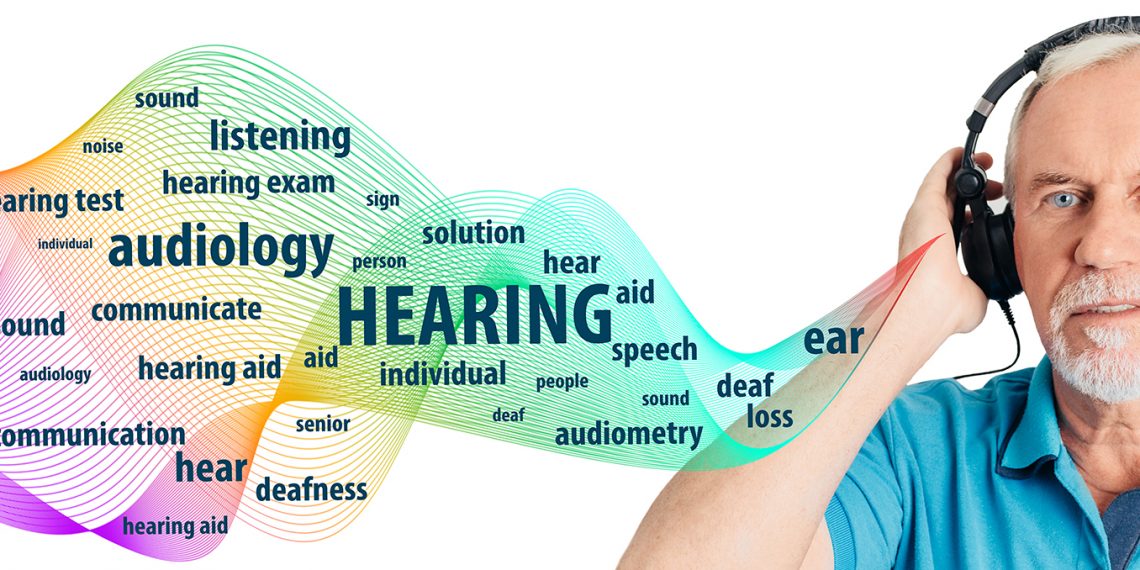 Senior man wearing headphones having hearing test. Audiometry, hearing exam and hearing treatment elderly patient.