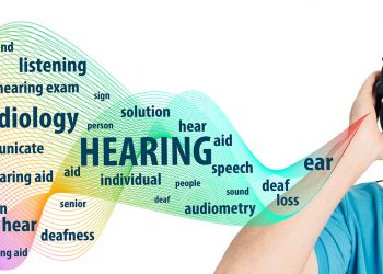 Senior man wearing headphones having hearing test. Audiometry, hearing exam and hearing treatment elderly patient.